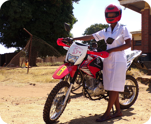A nurse standing beside her motorbike in Malawi